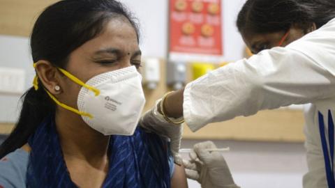 Health worker getting a Covid jab in Hyderabad, India.