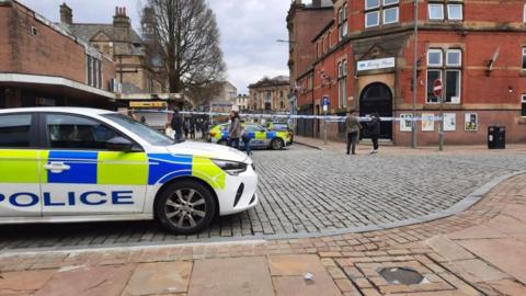 police cars at cordoned section in Darwen