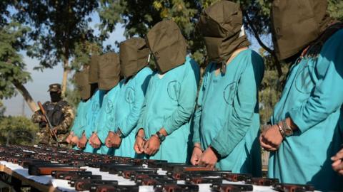 Suspected Islamic State (IS) and Taliban militants are brought before media during a press conference in Jalalabad on December 6, 2016.