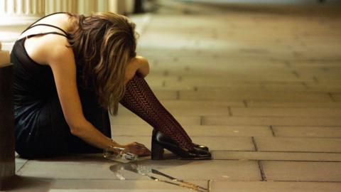 Woman slumped on pavement