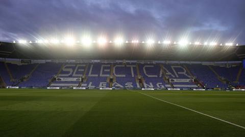 A general view of the SCL Stadium in Reading ahead of a match against Northampton Town in October. It is dark outside and the stadium's floodlights are on.