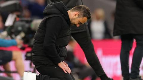Roberto De Zerbi slumps to his knees during Tottenham Hotspur's draw at home to Leeds United.