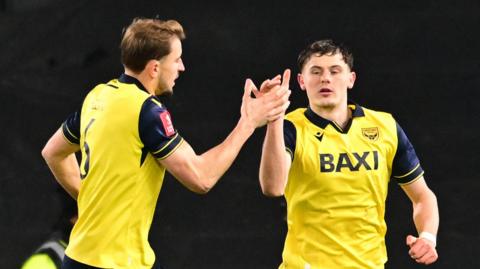 Oxford's Will Lankshear (right) celebrates his equaliser at MK Dons with Michal Helik