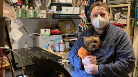 Mark Kelly and his support dog Gizmo - he now runs a mobile phone repair and accessory shop in Neath Market.