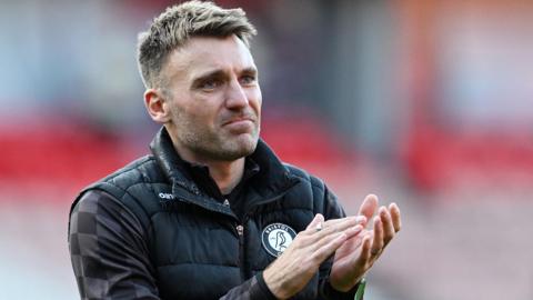 Chris Manning applauds fans during his time as Bristol City assistant head coach