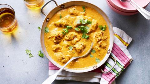 A bowl of chicken korma curry.