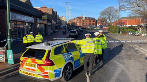 Several police officers and police car at the scene after three people were hit by a car in Main Street, Bulwell.