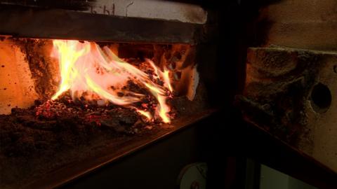 Burning wood pellets in a biomass boiler