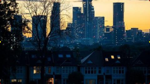 A night view of tower blocks over London.