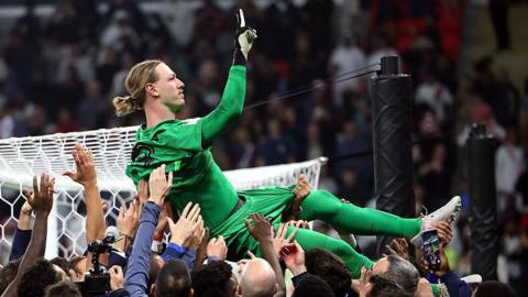Matvey Safonov of Paris St-Germain is thrown into the air by his teammates after they win the penalty shoot out during the FIFA Intercontinental Cup 2025 final match between Paris Saint-Germain and CR Flamengo