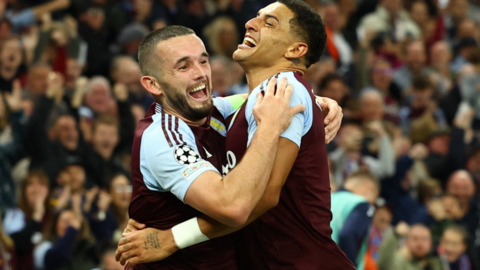 Aston Villa's John McGinn celebrates scoring their first goal with Diego Carlo