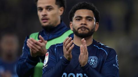 Coventry City's Jay Dasilva claps the crowd after a game
