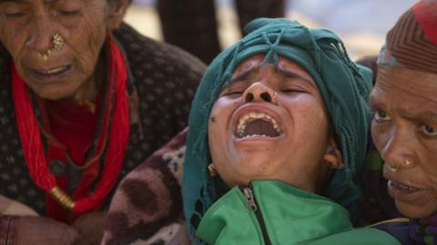 Family members mourn during the cremation of earthquake victims at Chiuri village in Jajarkot, Nepal, 05 November 2023.