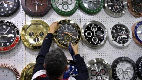 A man changes the time at a clock and watch shop in Beirut, Lebanon (27 March 2023)