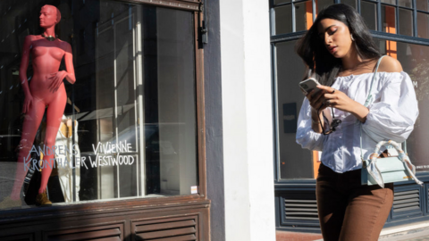 Woman walks past shop