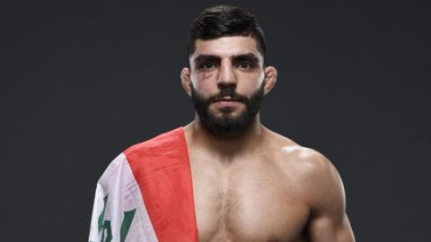 Amir Albazi with an Iraqi flag on his shoulder