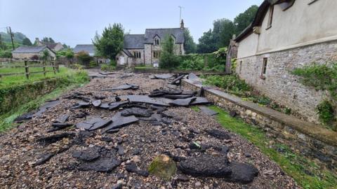 Chunks of tarmac broken up on a road