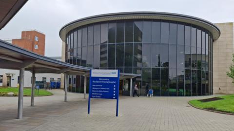 Image shows the glass-fronted entrance to Blackpool Victoria Hospital. 