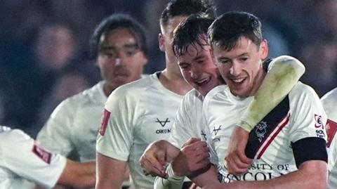 Lincoln City players celebrate with goalscorer Conor McGrandles 