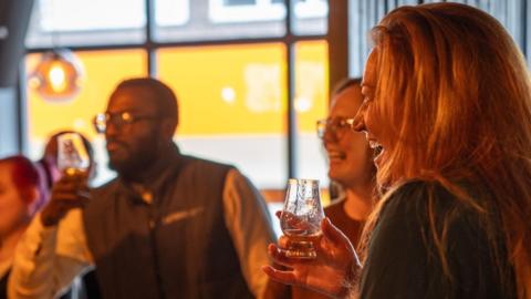 A group of people enjoying cocktails at a bar