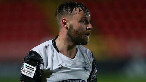 Gateshead player Harry Chapman, in white shirt with black trim.