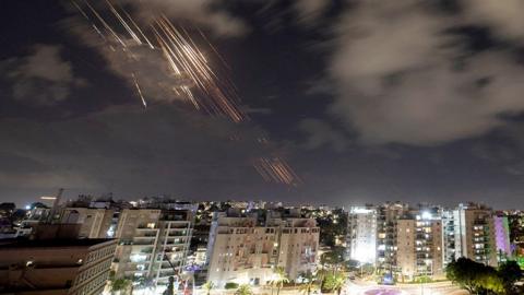 Missiles rain down from the night sky over the city as Israel's Iron Dome anti-missile system intercepts rockets after Iran fired a salvo of ballistic missiles, as seen from Ashkelon, Israel, October 1, 2024