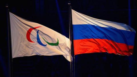 The flags of the International Paralympic Committee and Russia flying side by side
