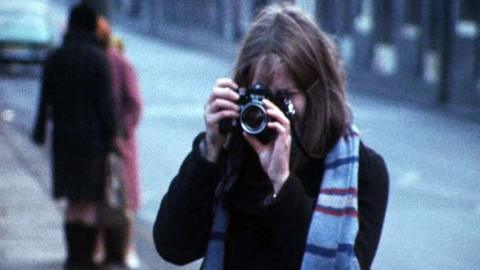 Photographer Sirkka-Liisa Konttinen readies to take a photograph with her camera.