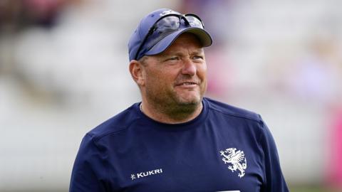 Trevor Griffin wearing a cap and sunglasses on top during a match this season