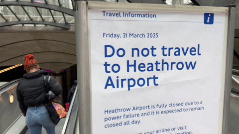 Sign at an underground station advising people not to travel to Heathrow Airport due to closure following a power failure 