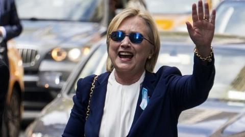 Hillary Clinton waves to photographers after leaving her daughter's home in New York (11 September)