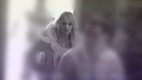 A black and white still image from CCTV footage of Lisa Dorrian entering Saltwater Brig restaurant in Kircubbin on 26 February 2005.  She has long, straight blonde hair and is wearing a heavy coat  and a pale top. 