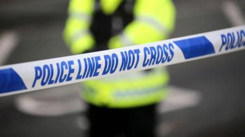 Generic image of a police cordon with an officer in high-vis out of focus in the background
