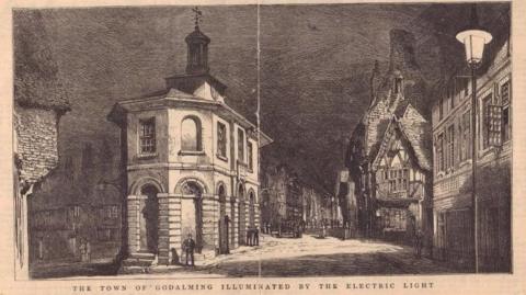 A black and white postcard image of Godalming.