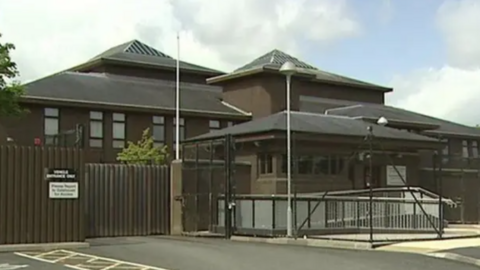 Craigavon courts. It is a brown building with a black fence around the entrance.