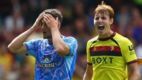 Taylor Harwood-Bellis reacts to a late miss with hands on head while Watford's Hector Kyprianou celebrates 