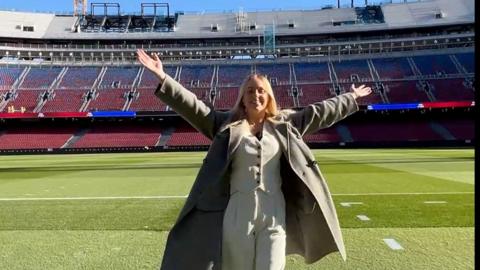 A woman stands on the field at Barca's new Camp Nou