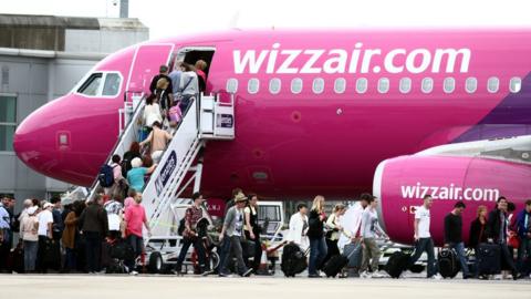 Passengers getting off a Wizz Air flight at Luton AIRPORT.