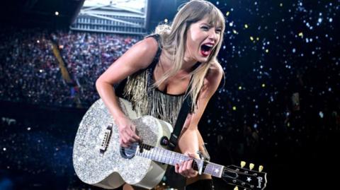 Taylor Swift plays guitar at Principality Stadium