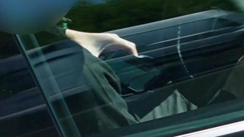 Man has mobile phone in hand while driving on the M25