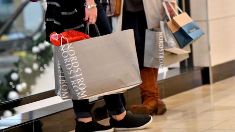 people holding shopping bags