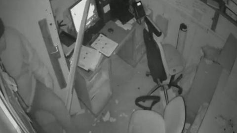 CCTV showing a man inside an office-style room