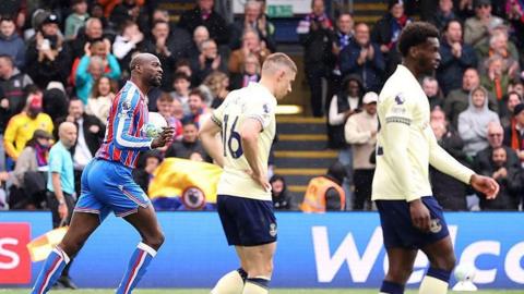 Jean-Philippe Mateta carries the ball in his hands past two Everton players after scoring
