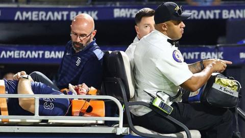 Hunter Bigge of the Tampa Bay Rays is taken off the field after getting hit by a foul ball