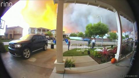 Doorbell footage shows residents fleeing their homes in California as a wildfire spreads nearby