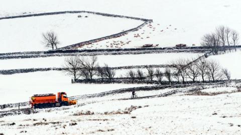 A gritter in the Peak District National Park, as heavy snowfall across parts of the UK is causing widespread disruption