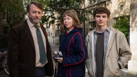 L-R: John ‘Ludwig’ Taylor (DAVID MITCHELL); Lucy Betts-Taylor (ANNA MAXWELL MARTIN); Henry Betts-Taylor (DYLAN HUGHES)