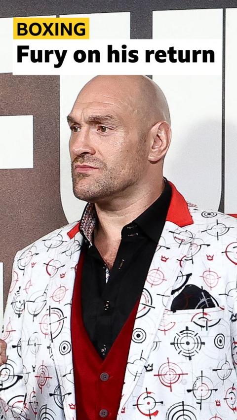 Tyson Fury at a press conference ahead of his fight on Saturday. He is wearing a white suit jacket.