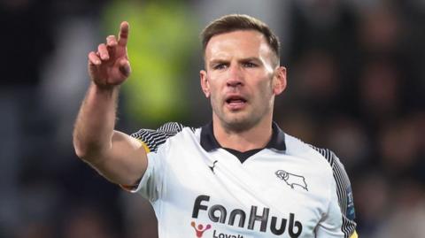 Derby's Andi Weimann raises his arm to signal for the ball