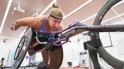 Wheelchair racer Hannah Cockroft training in a gym.